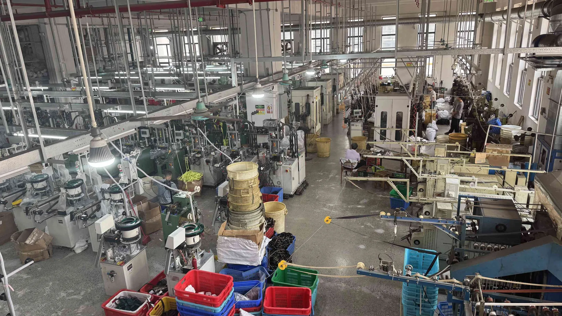 CEO Zipper factory floor with multiple zipper production lines in operation