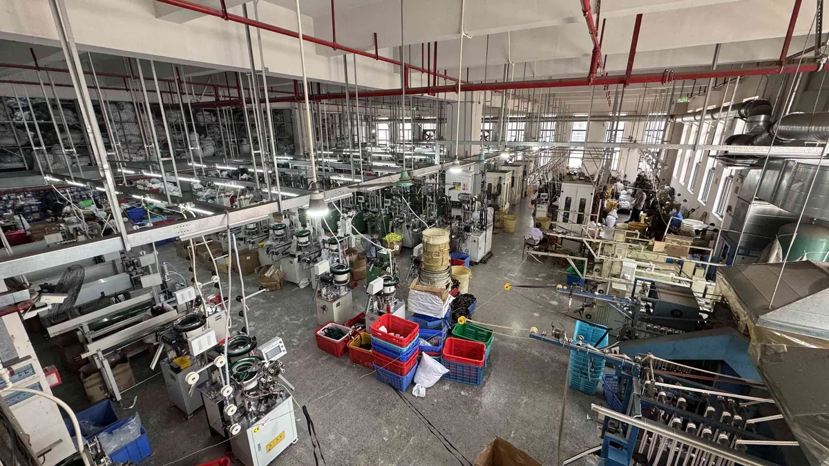 CEO Zipper factory floor with multiple zipper production lines in operation